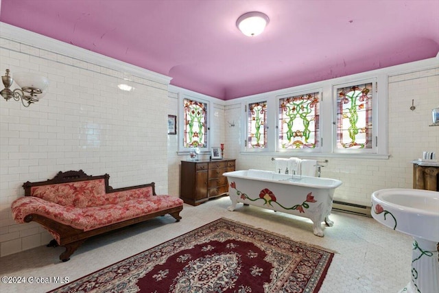 bathroom with a bathing tub and a baseboard heating unit