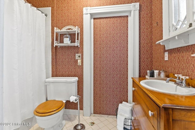 bathroom featuring vanity, tile patterned floors, and toilet