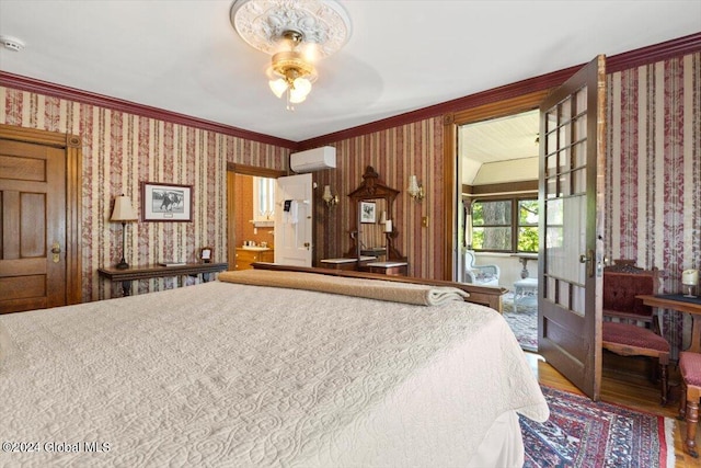 bedroom featuring ornamental molding, an AC wall unit, ceiling fan, and hardwood / wood-style floors