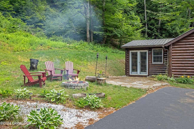 view of yard with a fire pit and an outbuilding