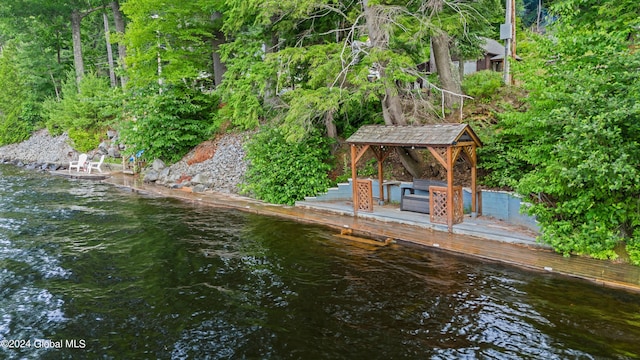 view of dock featuring a gazebo and a water view