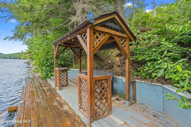 wooden deck featuring a water view