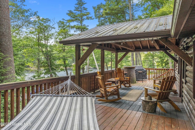 deck featuring a grill and a water view