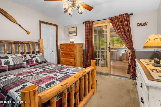 bedroom with lofted ceiling and light colored carpet