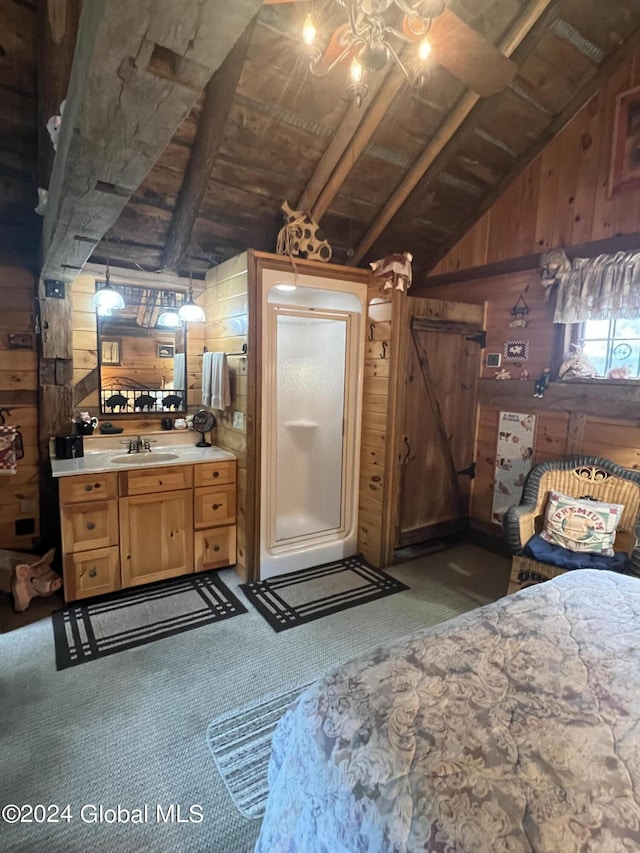 bathroom with vanity, vaulted ceiling with beams, and wooden walls