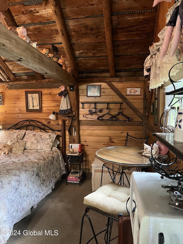 unfurnished bedroom with wooden ceiling, wooden walls, carpet floors, and vaulted ceiling with beams