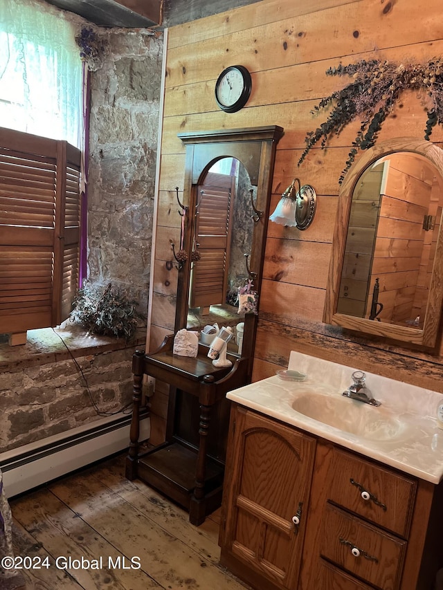 bathroom featuring vanity, a baseboard heating unit, and hardwood / wood-style flooring