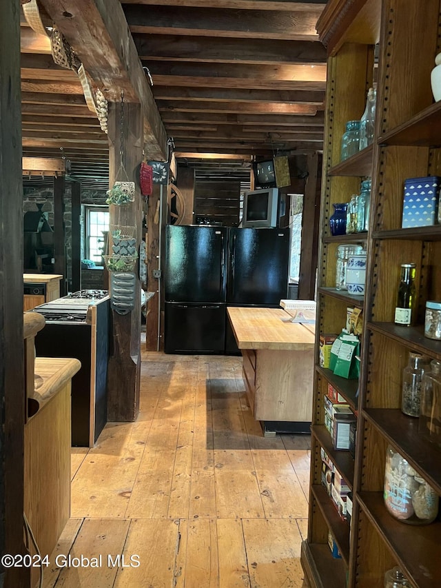 kitchen featuring black fridge and light wood-type flooring