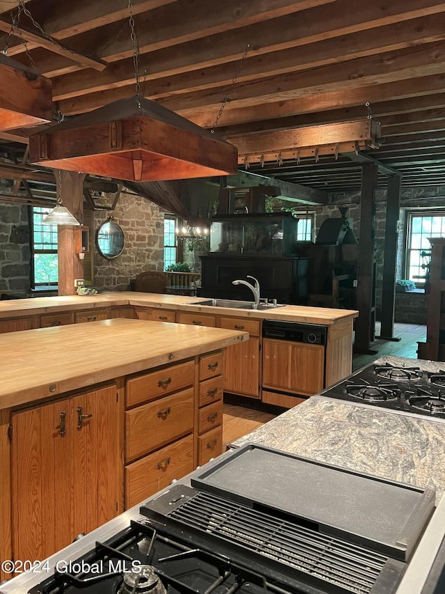 kitchen featuring gas cooktop, butcher block counters, dishwasher, and sink