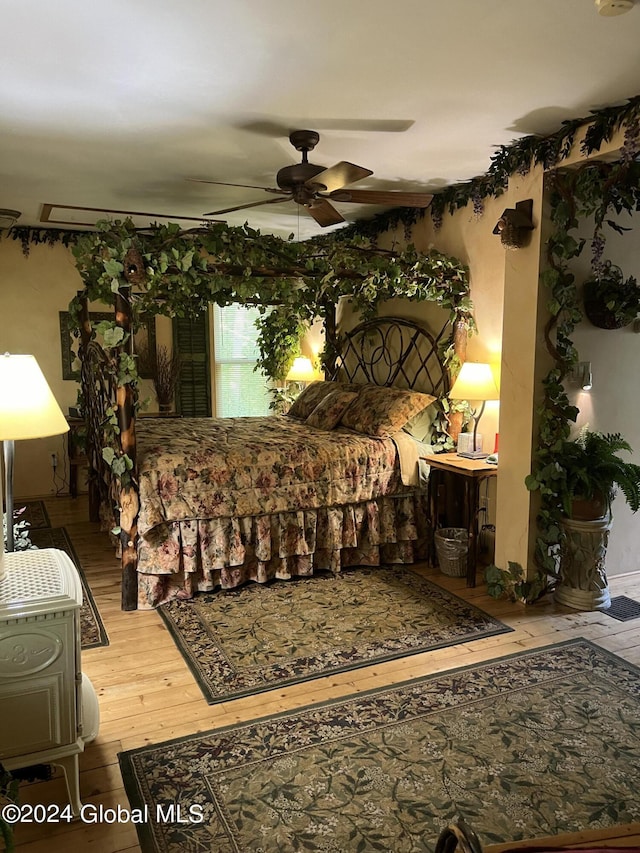 bedroom with wood-type flooring and ceiling fan