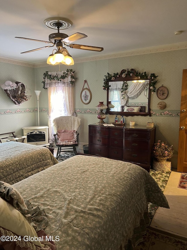 bedroom featuring ceiling fan and ornamental molding