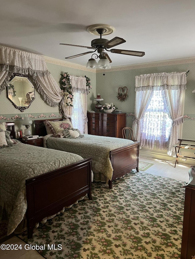 bedroom featuring crown molding, carpet flooring, and ceiling fan