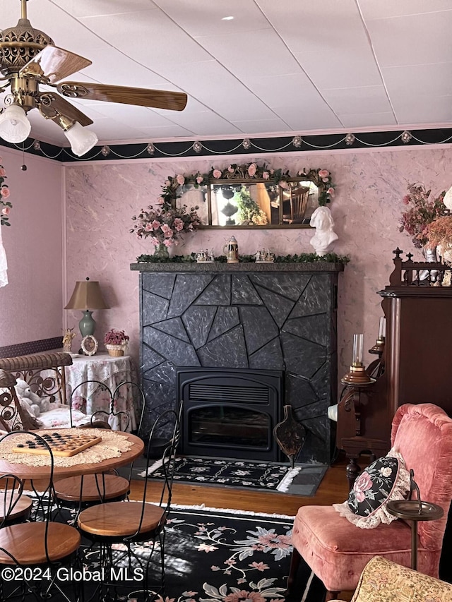 living room featuring heating unit, hardwood / wood-style flooring, and ceiling fan