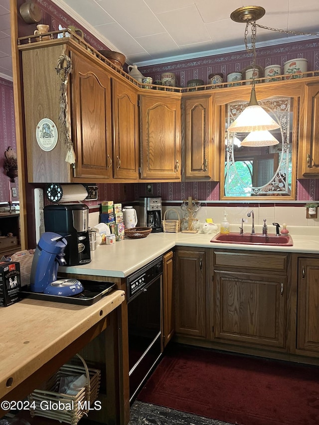 kitchen featuring sink, decorative light fixtures, and dishwasher