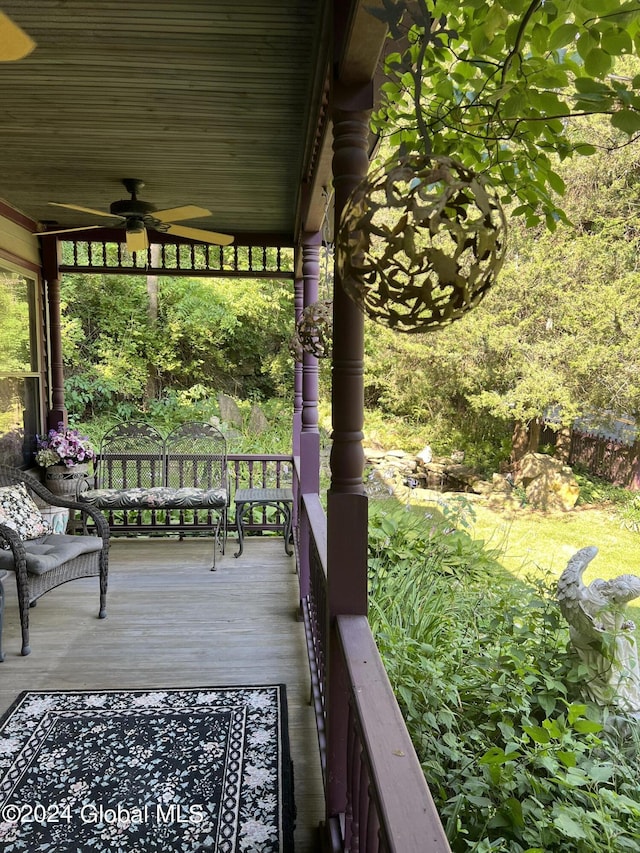 wooden terrace featuring ceiling fan