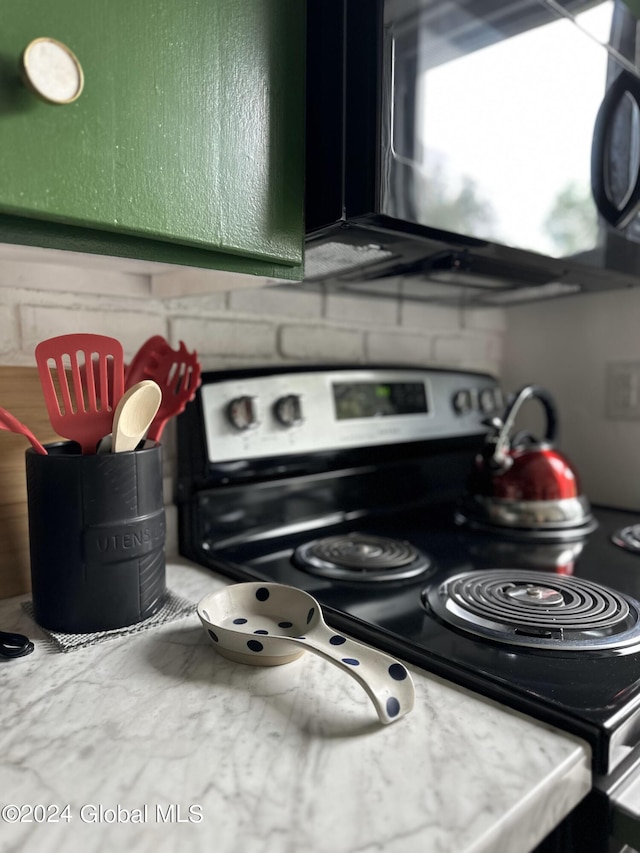 details with light countertops and stainless steel range with electric stovetop