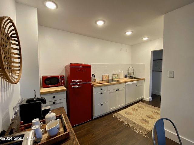 kitchen with tasteful backsplash, dark wood-style floors, white dishwasher, fridge, and white cabinetry