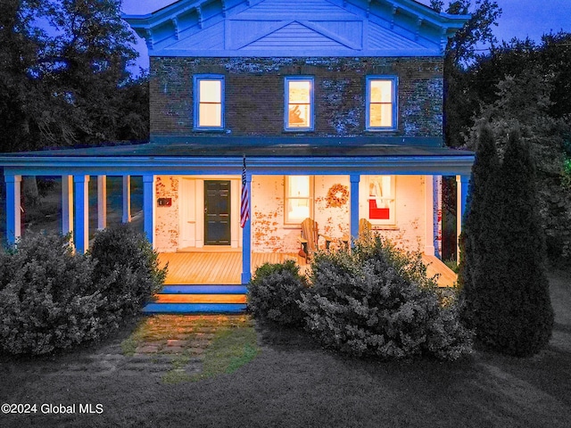 rear view of property featuring a wooden deck