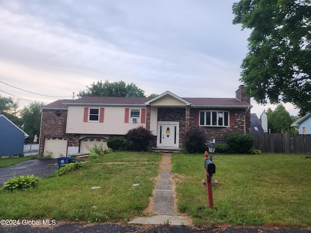 view of front of property with a garage and a front yard