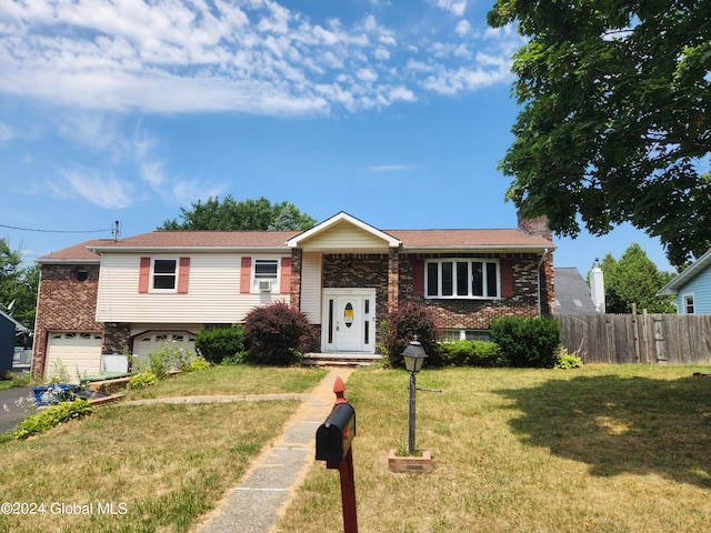 122 Massachusetts Ave, Cohoes, NY 12047 - raised ranch featuring a front yard and a garage