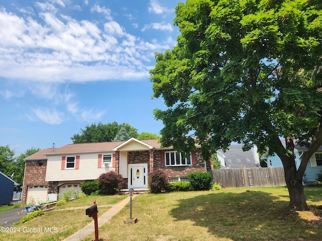 view of front facade with a garage and a front lawn