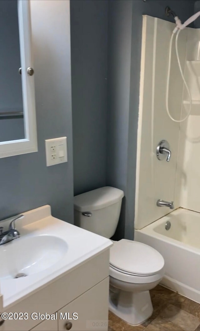 full bathroom featuring washtub / shower combination, toilet, vanity, and tile patterned flooring