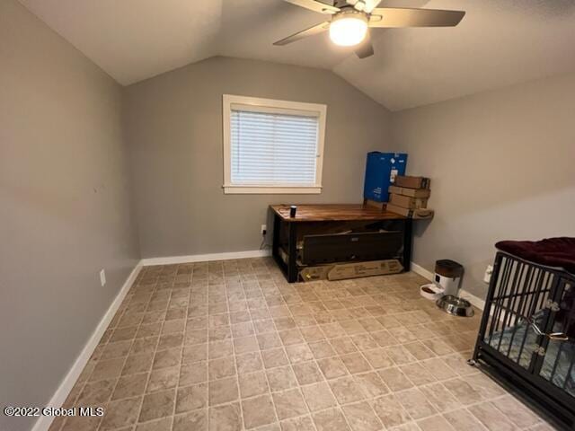 misc room with lofted ceiling, light tile patterned floors, and ceiling fan