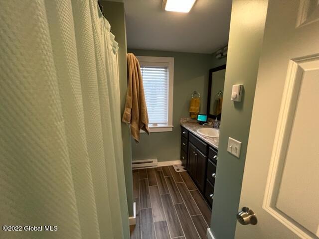 bathroom with a baseboard radiator and vanity