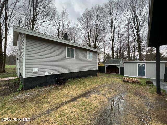 view of home's exterior featuring a storage unit