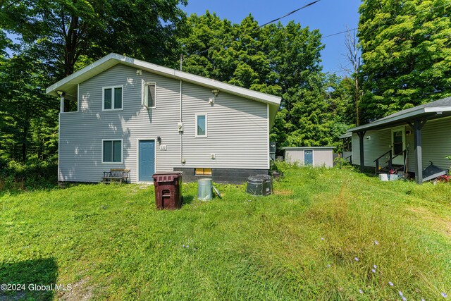 rear view of property featuring a lawn