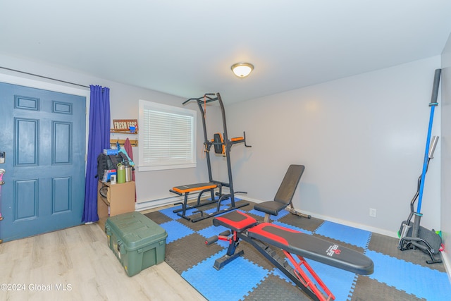 exercise room with light hardwood / wood-style flooring