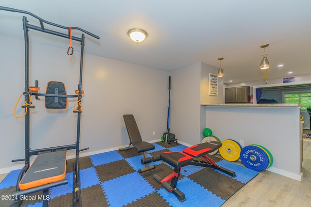 workout room with hardwood / wood-style flooring