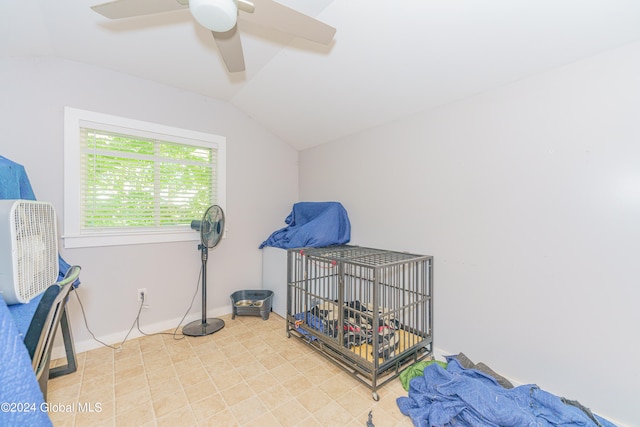 bedroom featuring light tile patterned floors, lofted ceiling, and ceiling fan