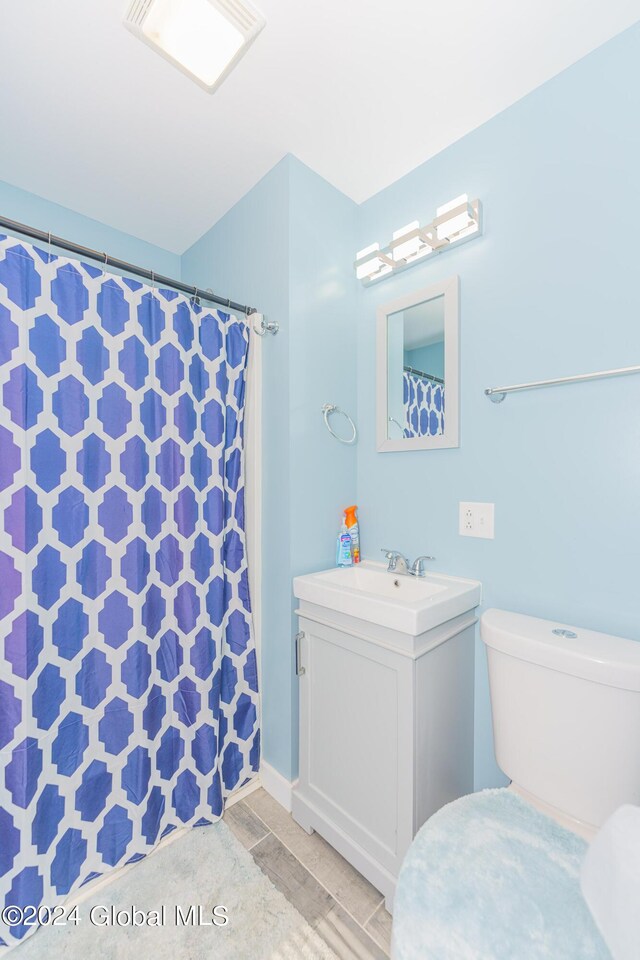 bathroom with vanity, tile patterned flooring, and toilet