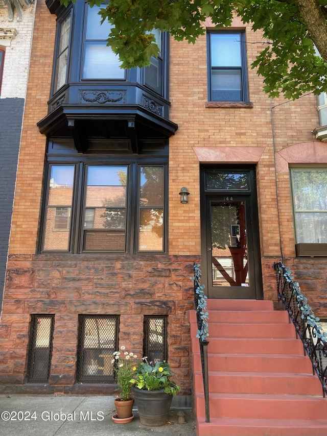 property entrance featuring brick siding