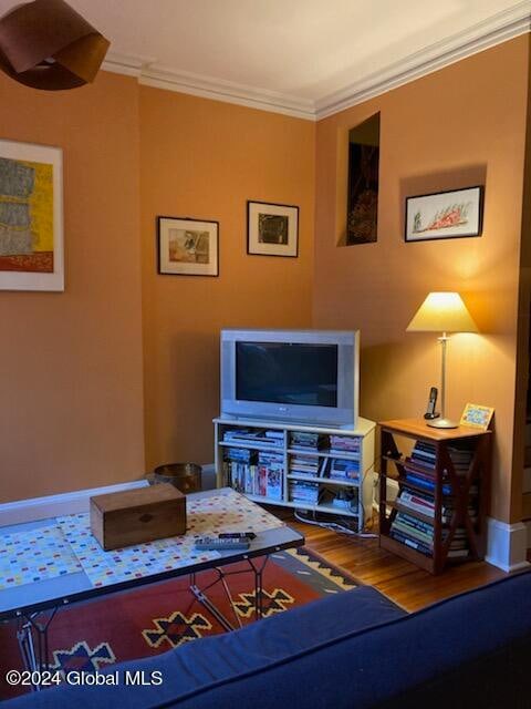 living room featuring crown molding and hardwood / wood-style floors