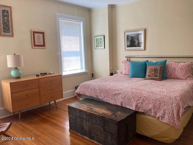 bedroom featuring crown molding and hardwood / wood-style flooring