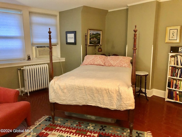 bedroom with crown molding, hardwood / wood-style flooring, radiator heating unit, and cooling unit