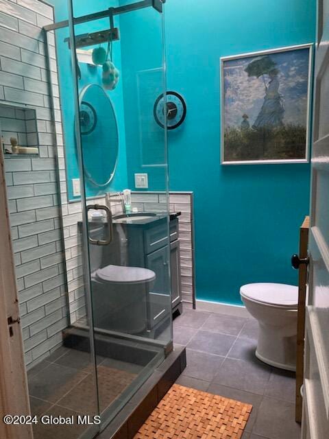 bathroom with vanity, toilet, and tile patterned flooring