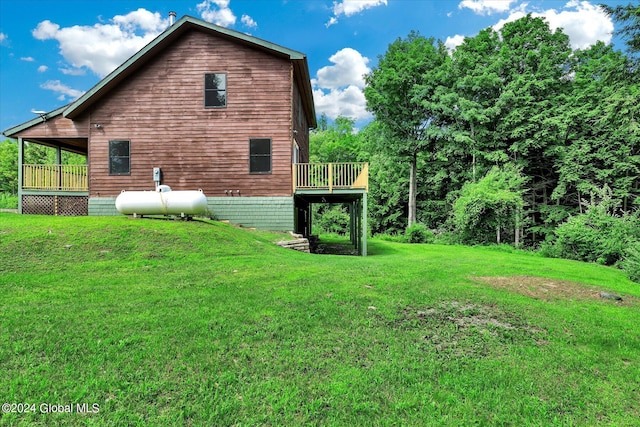 rear view of house with a lawn and a deck