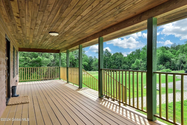 wooden deck with a lawn