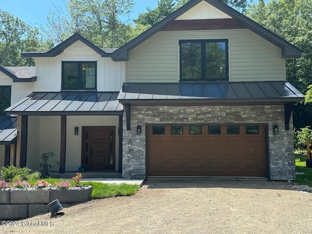 modern farmhouse with a garage and covered porch