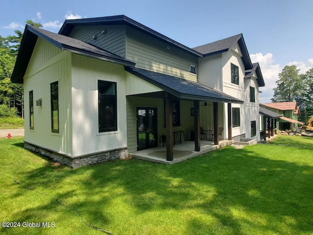 rear view of house with a lawn and a patio area