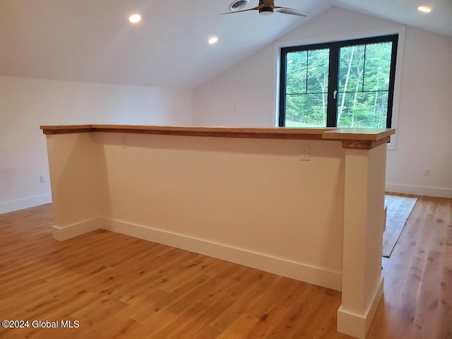 additional living space featuring lofted ceiling, ceiling fan, and light wood-type flooring