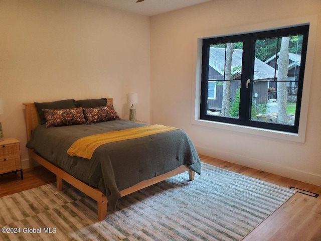 bedroom with hardwood / wood-style floors