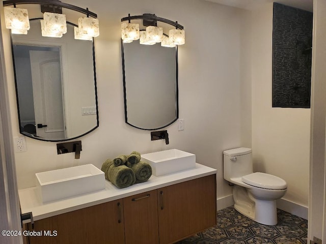 bathroom featuring vanity, tile patterned floors, and toilet