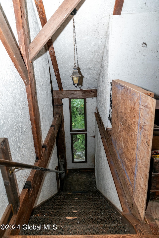 staircase featuring lofted ceiling