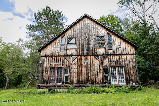 back of house with a lawn