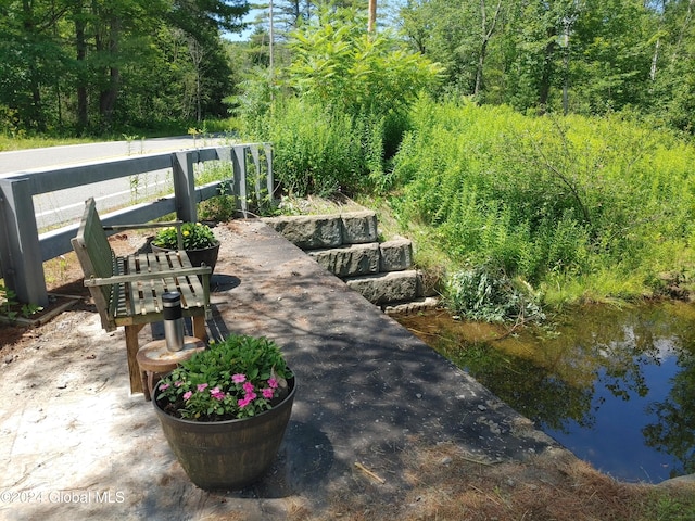 view of patio with a water view