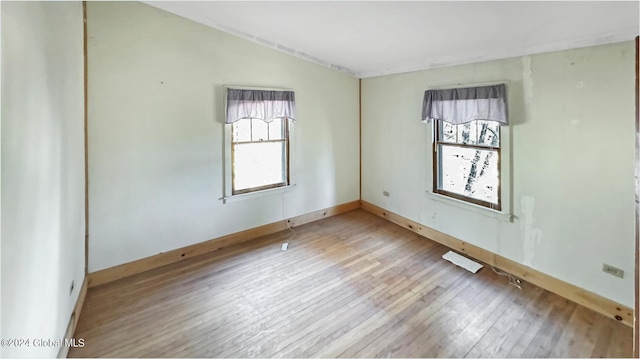 spare room with hardwood / wood-style floors